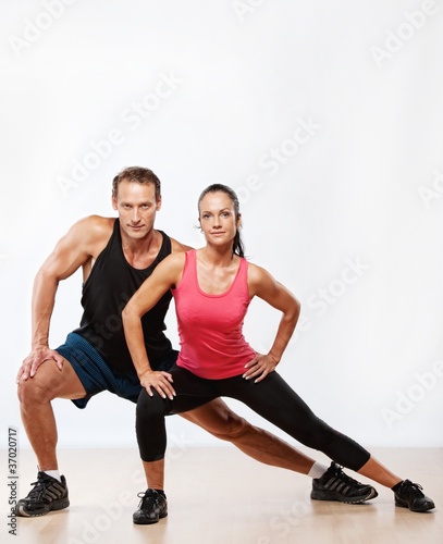 Photo: Athletic man and woman doing fitness exercise Athletic man and woman doing fitness exercise