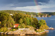 rainbow under small village rainbow under small village