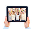 Tablet computer and group of happy people.