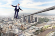 Business man balancing on the rope
