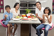 Asian Indian Parents Children Family Eating Healthy Food in Kitc