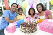 Asian Indian Family Celebrating Birthday Party WIth Chocolate Ca