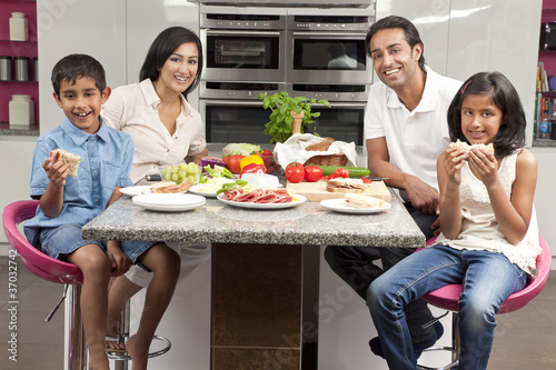 Photo: Asian Indian Parents Children Family Eating Healthy Food in Kitc Asian Indian Parents Children Family Eating Healthy Food in Kitc