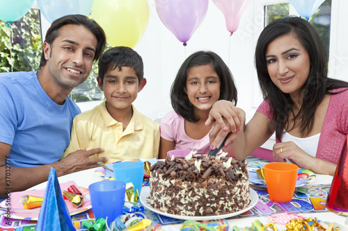 Photo: Asian Indian Family Celebrating Birthday Party Cutting the Cake Asian Indian Family Celebrating Birthday Party Cutting the Cake