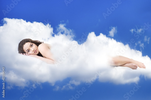 Photo: beautiful woman lying on clouds beautiful woman lying on clouds