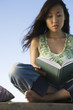 Woman reading book outdoors