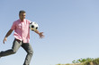 Man playing with soccer ball outdoors, smiling