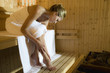 Woman relaxing in sauna
