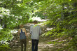Couple walking in woods, rear view