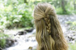 Girl contemplating stream, rear view