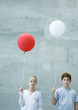 Two children holding balloons