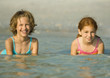Girls in ocean, smiling