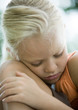 Girl leaning head against knee