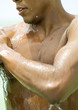 Man with water running from skin, close-up of chest
