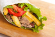 beef burrito with peppers, fried potato and tomato