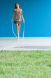 Teenage girl jumping rope, full length