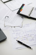Hand written business plan on cluttered desk