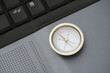 Compass on laptop computer, close-up