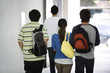 Students walking together in corridor, rear view