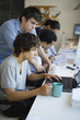 Male college students working together using laptop computer