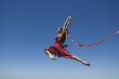Young woman leaping, midair
