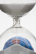 Hourglass, globe in background