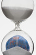 Hourglass, globe in background