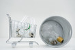 Photo: Shopping cart containing energy efficient light bulbs next to garbage can containing conventional light bulbs Shopping cart containing energy efficient light bulbs next to garbage can containing conventional light bulbs