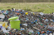 Full garbage can in midst of landfill