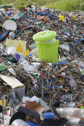 Photo: Full garbage can in midst of landfill Full garbage can in midst of landfill