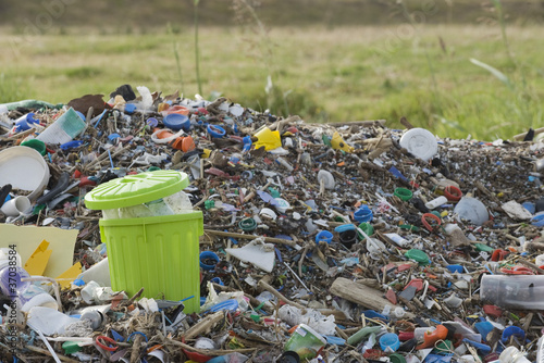 Photo: Full garbage can in midst of landfill Full garbage can in midst of landfill