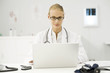Female doctor using laptop at desk
