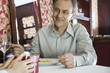 Mature man giving gift to woman in restaurant