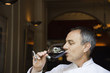 Mature man drinking red wine
