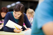 Photo: pretty female college student sitting in a classroom pretty female college student sitting in a classroom