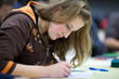 Photo: pretty female college student sitting in a classroom pretty female college student sitting in a classroom