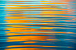 Blue waves reflecting orange sunset