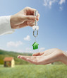Man is handing a house key to a woman