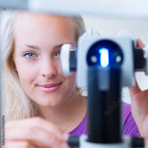 Photo: optometry concept - pretty, young female patient optometry concept - pretty, young female patient