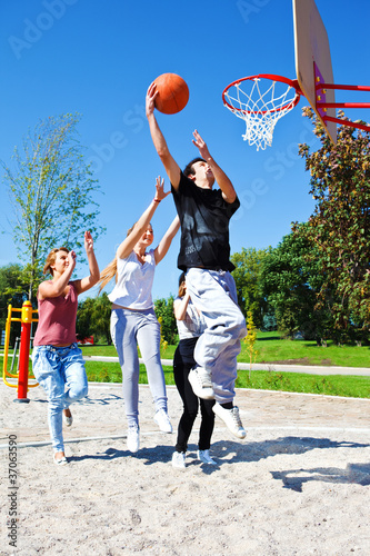 Photo: Teenagers playing basketball Teenagers playing basketball