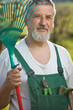 portrait of a senior man gardening in his garden