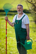 portrait of a senior man gardening in his garden