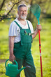 portrait of a senior man gardening in his garden