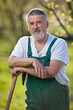 portrait of a senior man gardening in his garden