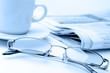 Eyeglass and newspaper