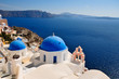 Two blue domes and their bell tower in Oia - Santorini - Greece