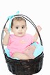 Cute Indian baby in a wooden basket.