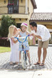 Foto: Family WIth Girl Riding Bike & Happy Parents Family WIth Girl Riding Bike & Happy Parents