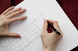 Hands and blueprint