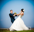 Newly married couple dancing in field Newly married couple dancing in field